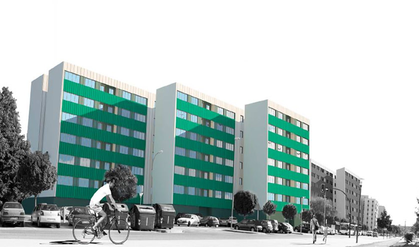 Fotografía de tres edificios verdes y una persona montando en bicicleta