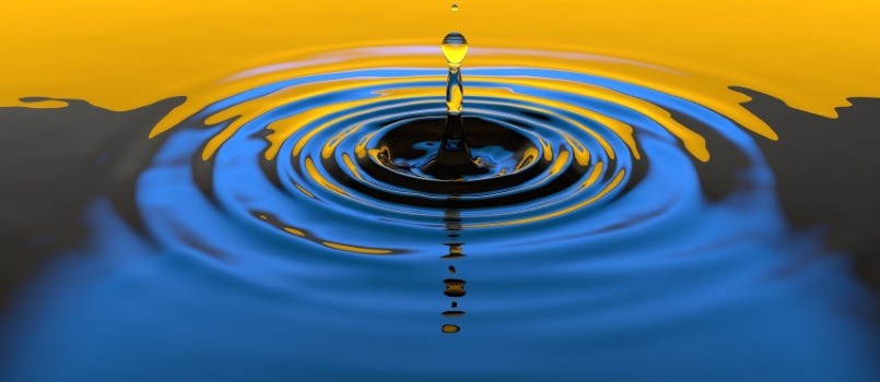 Fotografía de un charco de agua con una gota cayendo.