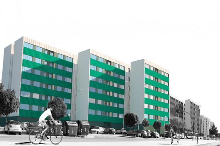 Fotografía de tres edificios verdes y una persona montando en bicicleta