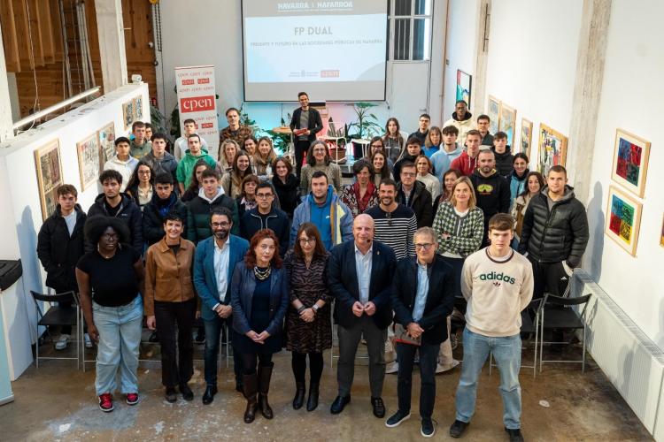 Fotografía de grupo de todas las personas asistentes al encuentro mirando a cámara, que está situada en una entreplanta superior