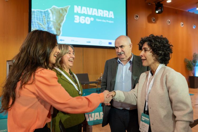 Fotografía de 4 personas hablando y estrechando manos